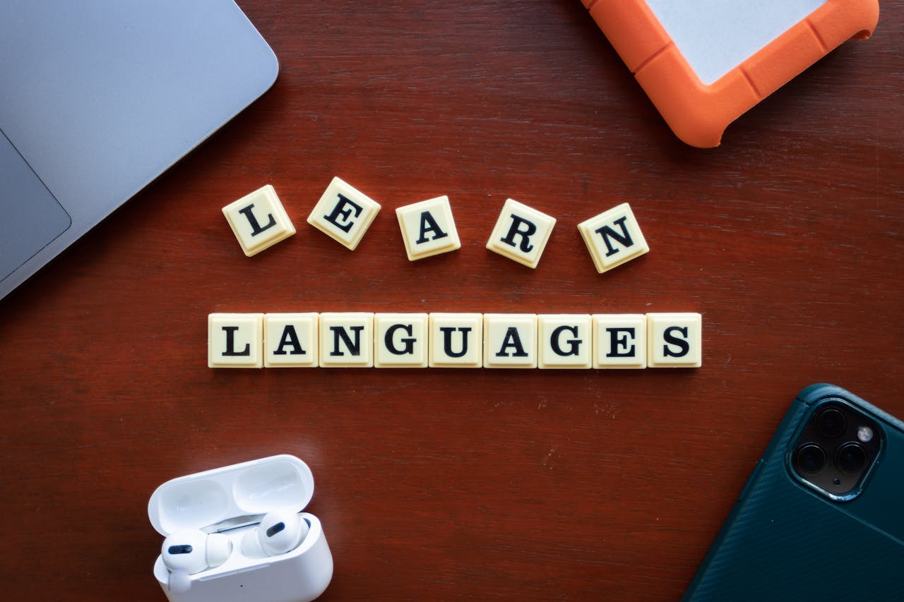 services-img Flat lay of language learning materials with gadgets promoting education.